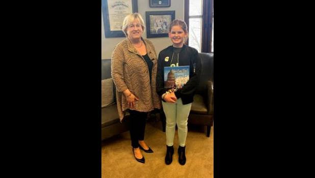 Senator Karla Eslinger presented a copy of "You Can, Too!" a book recounting the history of women in the Missouri Senate, to Eliza Salladay, who visited the office as part of the Missouri Developmental Disability Council's Disability Rights Legislative Day at the Capitol. photo provided