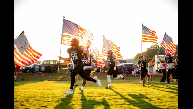 The Liberty Eagles hosted long time rivals the Thayer Bobcats on Friday night in the first SCA battle of the season. The game was a barn burner from the beginning to the very last second with Liberty taking a narrow victory by just two points over the Bobcats, 28-26. The Eagles are now 3-0 on their season. The Friday night game happened to fall on Patriot's Day, Sept. 11 and the Eagles came out soaring with American pride waving American Flags as they took the field. Howell County News/ Kacey Blunk