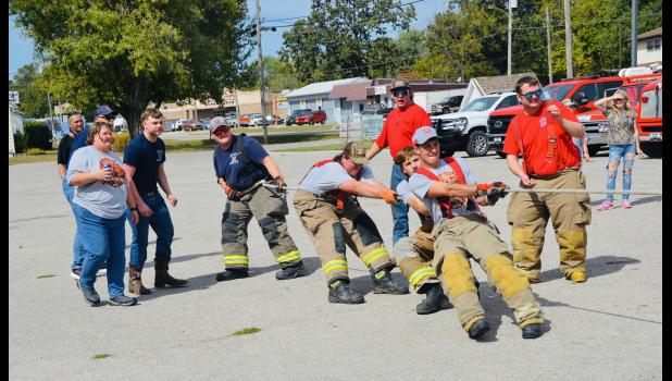 Cheered on by various supporters, four Howell County Rural firefighters compete in the firefighter vs. firefighter tug-a-war competition. In the end, although tired, they took home the trophy! Howell County News/Addison Smith