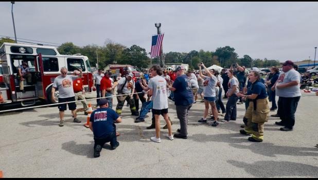 The annual fire fighter vs. police officer tug-a-war is always a strong competition. As the end drew near, the firefighters pulled through to victory. Pictured are community members, and family and friends of the firefighters cheering the firefighters on! Howell County News/Addison Smith