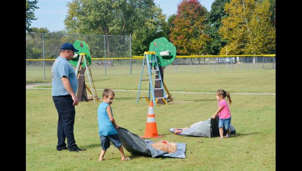 Willow Springs students Ashton and Arianna Stokes compete in a firefighting obstacle course guided by Sam Waldron, Willow Springs Asst. Fire Chief. Howell County News/Addison Smith