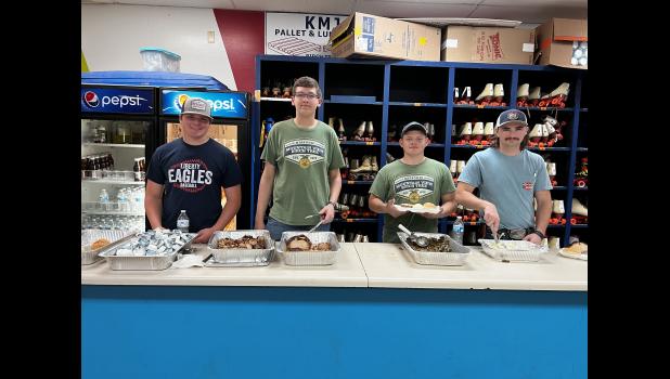 Jarren Rutledge, Drayton Wells, Tyler Glasscock, and Wyatt Honeycutt serve up Bootleggers BBQ during the FFA RAD Night. photo provided