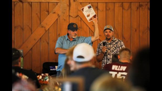 Mayor Adam Webb and auctioneer Eric King auction off a parking spot at Palenske Field for home games. courtesy of Shawana Cox