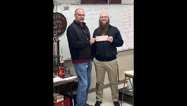 Mike Charlton, Willow Springs School District Band Director, is pictured above receiving the $5,000 check from Willow Springs High School Principal Nick Schmitt. photo provided