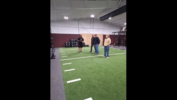 Travis Payne shows off The Bear Training Facility to (from left) John Bailey, Andy Roberts, and Elijah Roberts. Howell County News/ Amanda Mendez