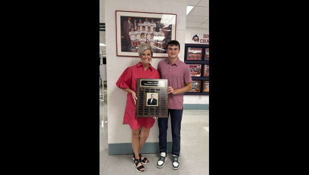Ashley Tyree Cooley, Justin Cooley's late wife, presents Gavin Reese with a $500 Justin Cooley Memorial Scholarship. photo provided