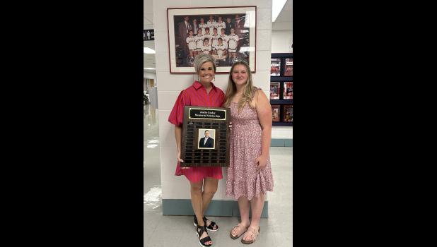 Ashley Tyree Cooley, Justin Cooley's late wife, presents Ashlyn Henry with a $500 Justin Cooley Memorial Scholarship. photo provided