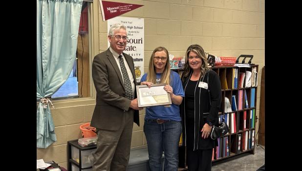 West Plains FFA teacher Tonya Jedlicka, Dave Higgins of the FFA Foundation, and Traci Wiley of Wiley Insurance presenting the award. photo provided