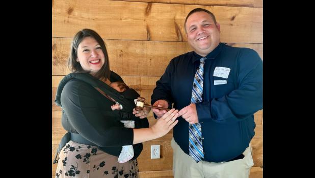 On the left, I am wearing my five-week-old daughter while accepting the president’s gavel for the Ozark Press Association. On the right is past president Ron Schott of the Wright County Journal. photo by Dan Wehmer