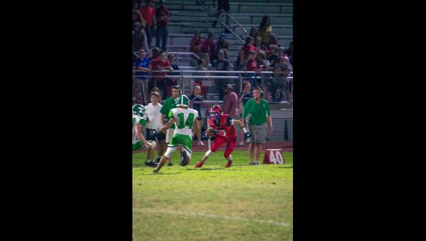 Sophomore Drew Ripko looking for a line around two Thayer defenders. (Howell County News/ Gretchen Creighton Photography)