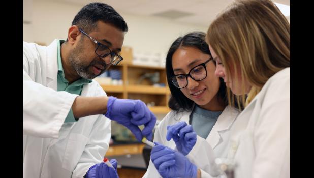 Dr. Sharath Rongali, left, assistant professor of biology at Missouri State University-West Plains (MSU-WP), identifies the reagents for DNA amplification to students Juliana Lopez, center, Lebanon, and Macie Tate, Mansfield, as part of an antibiotic-resistant bacteria research project. photo courtesy of MSU-WP
