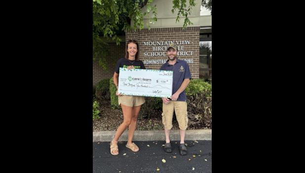 Kristy Reese, Care-to-Learn Liaison accepts a check from Nicholas Wester, Worshipful Brother of the Mountain View Masonic Lodge #637. photo provided