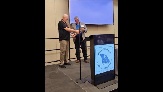 The former Howell County Surveyor, Ralph Riggs, is pictured presenting his brother, current Howell County Surveyor Ray Riggs with the Robert E. Myers Memorial Service Award. photo provided