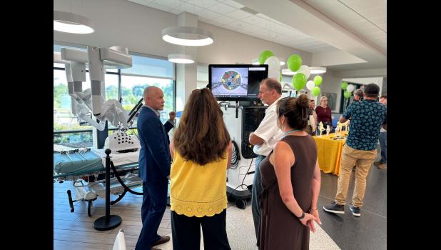 Mingle and Meet the Robots was held recently at Ozarks Healthcare. Together, with the West Plains Chamber of Commerce, community members were able to mix and mingle all while meeting the hospitals robots. Pictured: The da Vinci Surgical representative along with Jessica Collins, Joanne, and Brian White. photo provided