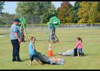 Willow Springs students Ashton and Arianna Stokes compete in a firefighting obstacle course guided by Sam Waldron, Willow Springs Asst. Fire Chief. Howell County News/Addison Smith