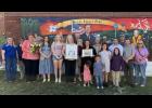 Members of the Willow Springs Chamber of Commerce were on hand Thursday, Aug. 13 to celebrate 25 years of business for Howell County News. Pictured, from left: City Clerk Heather Tooley, HCN Office Manager Marsha Asberry, Chamber Director Kim McCormick, Chamber board member Kimberly ALbin, Heidi Crosswhite, Holly Wehmer, Mayor Adam Webb, HCN Kim Rich, pictured holding her first issue, Chamber board member Robert Hollis, Publisher Amanda Mendez holding the Mendez family's first issue, Art Director Ron Mendez, Alderman Andy Roberts, Justin Frost of Simmons Banks, Chamber Ambassador Caleb Hines, Chamber Ambassador Sidney Collins, and Mary Roberts. The Mendez children were also present. From left, front row: Geanie, Joey, Bonnie, and Leo Mendez. Howell County News/Laura Wagner