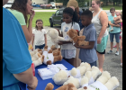Logan and Isrlia Dunn of Willow Springs rub hearts on their bears to bring them to life, according to Build-a-Bear tradition. Howell County News/Grace Long
