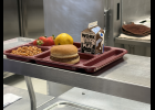 A hamburger made with locally sourced beef is served alongside baked beans, strawberries, an orange, and a chocolate milk during Willow Springs School District's annual MO Beef Day celebration on Oct. 9. Howell County News/Caleb Solik